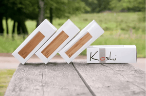 Koshi Wind Chimes full set displayed on a table with Koshi emblem, Aria, Terra, Ignis, Aqua