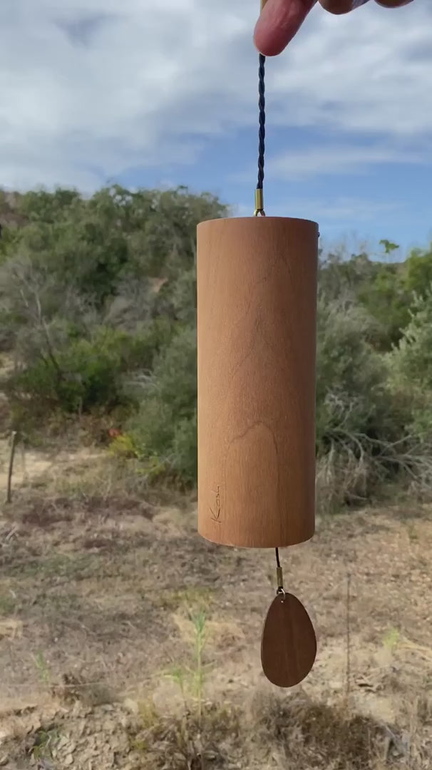 Koshi Mountain chime in walnut against a hillside landscape, video with the original sound of the Earth Symphony collection